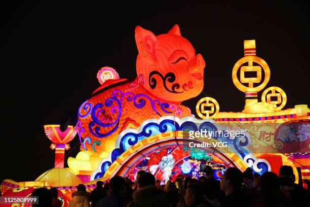 Colored lantern featuring a pig is illuminated during Xi'an city wall lantern show at a square for the Chinese New Year, the Year of the Pig, on...