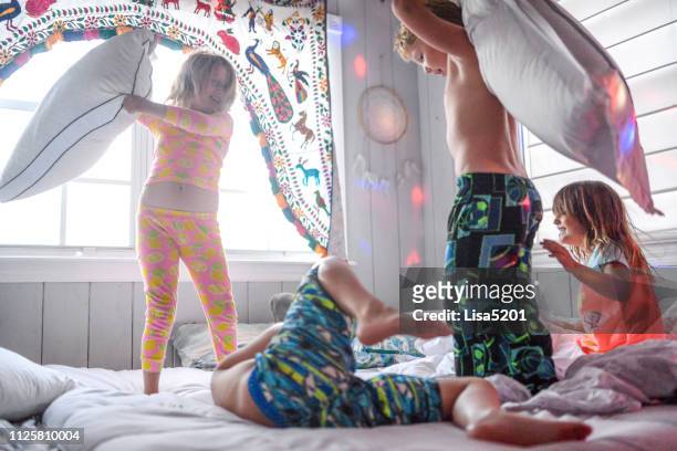 pillow fight dance party sleepover chaos and kids - uncultivated stock pictures, royalty-free photos & images