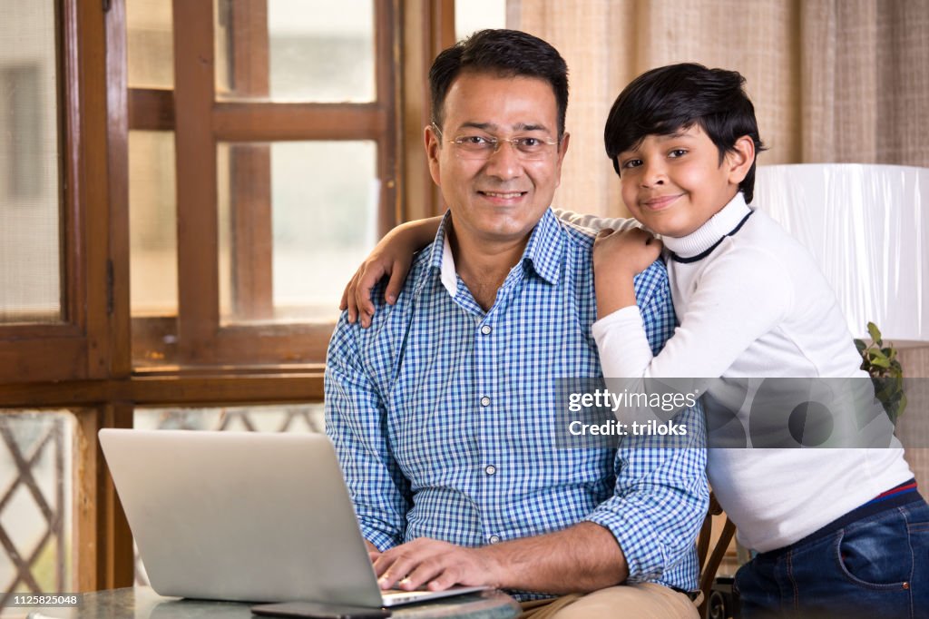 Son embracing his father at home