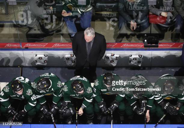 View from the top as head coach Dale Hunter of the London Knights watches from behind the bench as players look on during OHL game action against the...