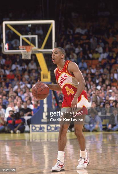 Spud Webb of the Atlanta Hawks dribbles the ball during a NBA game against the Los Angeles Lakers at the Great Western Forum in Inglewood, California...