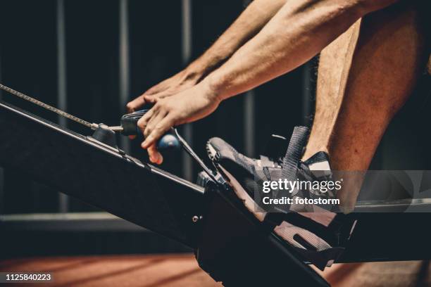 rowing machine workout - pulling stock pictures, royalty-free photos & images