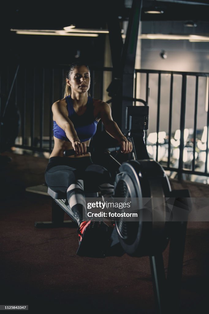 Woman doing seated row exercise at the gym