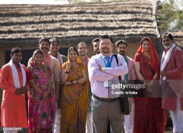 real estate agent with group of villagers - village stock pictures, royalty-free photos & images
