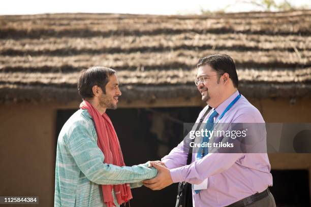 real estate agent with client at village - indian village people stock pictures, royalty-free photos & images