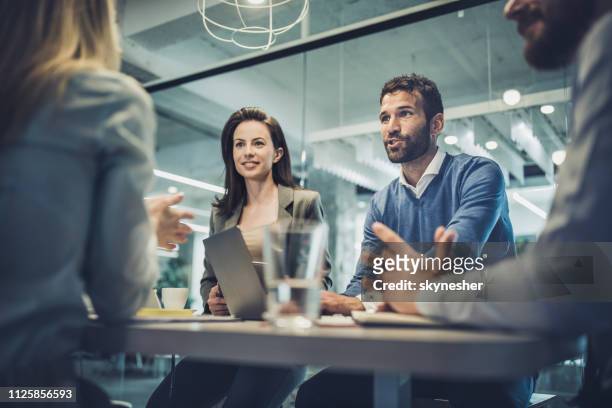 group of business people talking about new plans on a meeting in the office. - quartet stock pictures, royalty-free photos & images