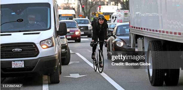 Vehicles block part of a bike lane on Main Street in Cambridge, MA, causing a bicyclist to compete with traffic, on Jan. 25, 2019. Cambridge has six...