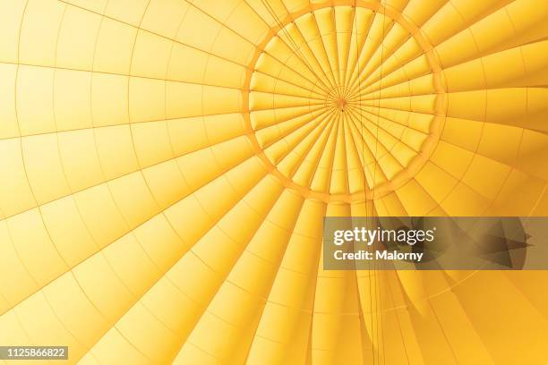 yellow hot air balloon. close-up of the yellow envelope. - ballon festival stock-fotos und bilder