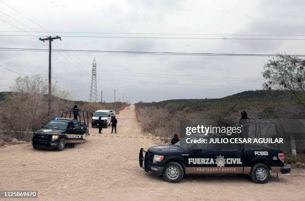 Mexican police guard the site where four men were murdered on a road in Pesqueria, Nuevo Leon, Mexico, on February 19, 2019.