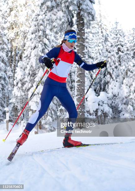 front view of female biathlon competitor practicing cross-country skiing - biathlon ski stock pictures, royalty-free photos & images