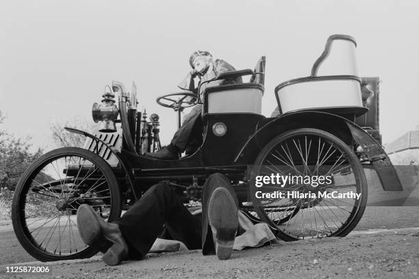 Man repairing his car at the London to Brighton Veteran Car Run, UK, 3rd November 1980.