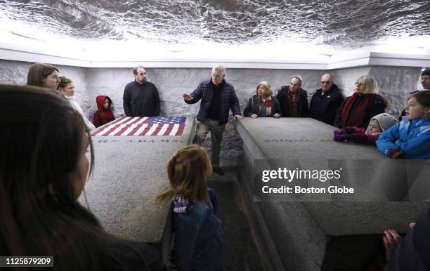 John Carroll, center, gives a brief history to visitors to the Adams Crypt, where, from left, John Adams, Abigail Adams, John Quincy Adams , and...