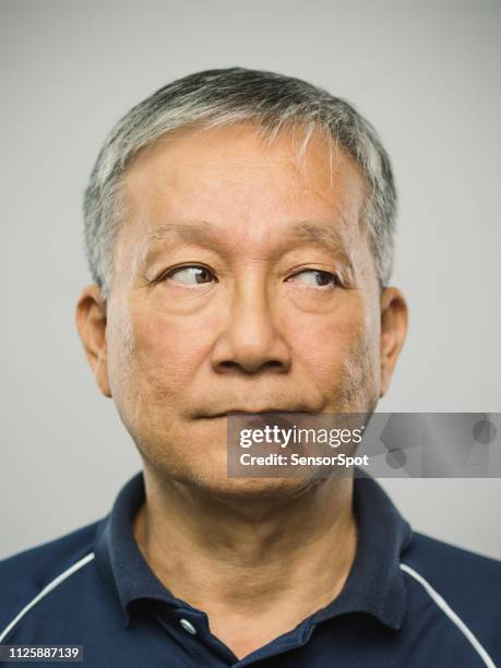 real chinese senior man with blank expression looking to the side - asian waiting angry expressions stock pictures, royalty-free photos & images