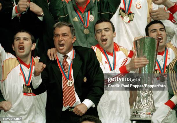 Arif Erdem of Galatasaray celebrates with the trophy alomngside manager Fatih Terim after the 2000 UEFA Cup Final between Galatasaray and Arsenal at...