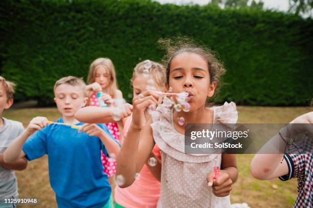 blowing bubbles with friends - bubble stock pictures, royalty-free photos & images