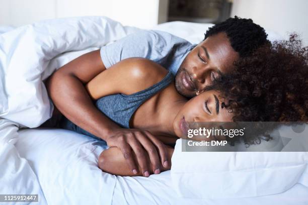 nothing compares to peaceful sleep - black man sleeping in bed stock pictures, royalty-free photos & images