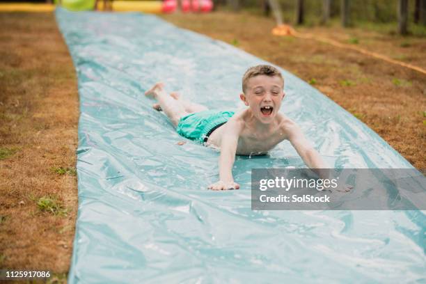 exciting slip 'n' slide activities - slippery stock pictures, royalty-free photos & images