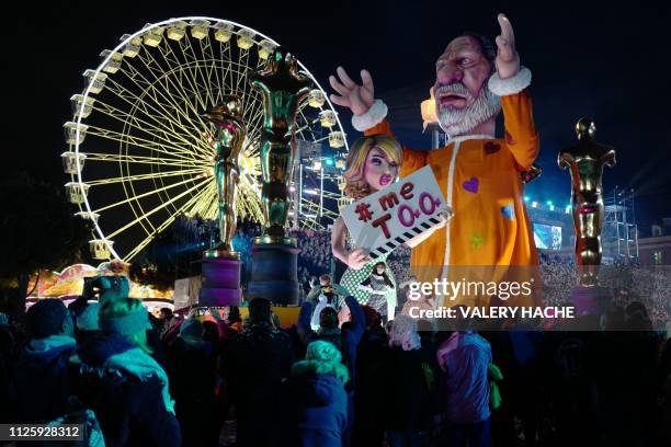 Float carrying a figure of US film producer Harvey Weinstein parades during the Nice Carnival Parade in Nice, south-eastern France on February 19,...