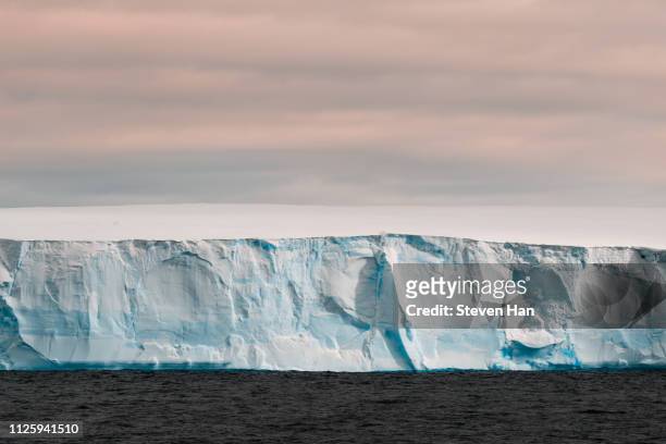 close-up view of iceberg at dusk in the antarctica - antarctica sunset stock pictures, royalty-free photos & images