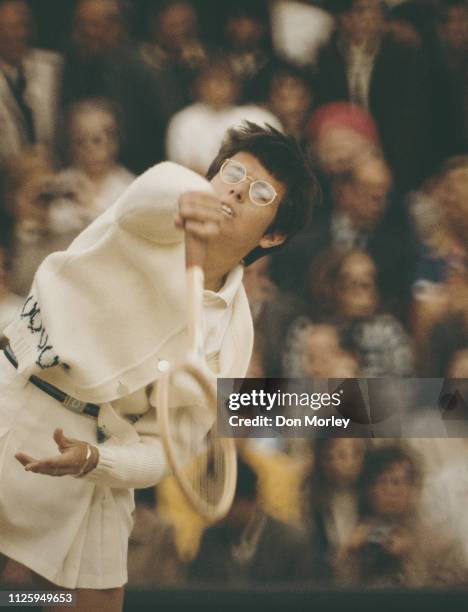 Billie Jean King of the United States serves to Margaret Court during the Women's Singles Final match at the Wimbledon Lawn Tennis Championship on 3...