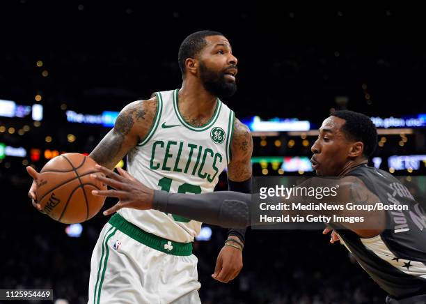 Marcus Morris of the Boston Celtics, left, is pressured by Rondae Hollis-Jefferson of the Brooklyn Nets during the first quarter of an NBA basketball...