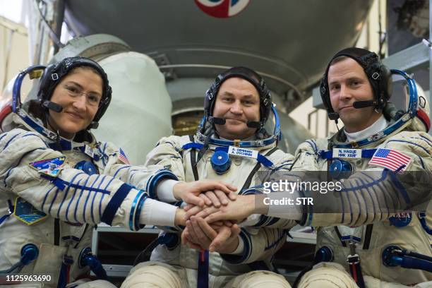 Members of the International Space Station expedition 59/60, NASA astronauts Christina Hammock Koch and Nick Hague and Russian cosmonaut Alexey...