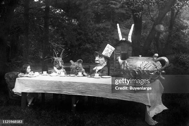 American actress Viola Savoy as the title character appears in the Mad Hatter's Tea Party scene from 'Alice in Wonderland' , New York, 1915. Also...