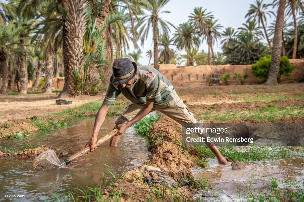 Man building wall of water channel