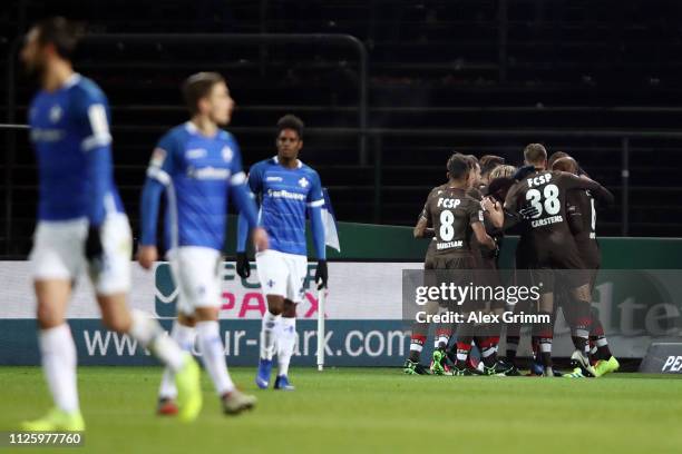 Ryo Miyaichi of St. Pauli celebrates his team's first goal with team mates during the Second Bundesliga match between SV Darmstadt 98 and FC St....