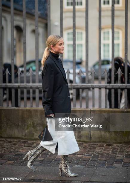 Josefine Haaning Jensen is seen wearing white skirt, YSL bag, boots with snake print outside MUF10 during the Copenhagen Fashion Week Autumn/Winter...