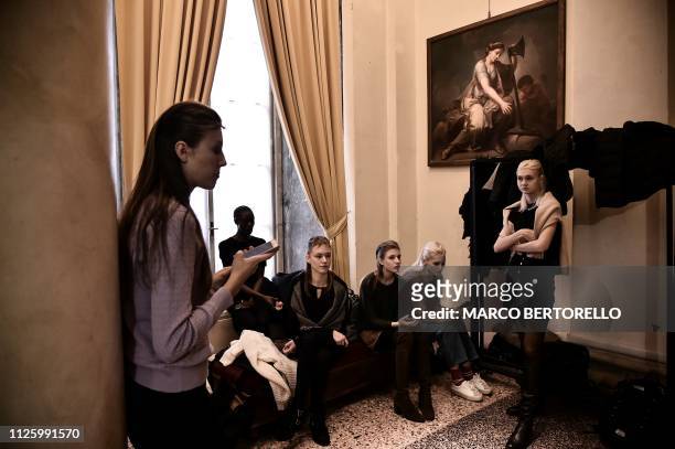 Models are pictured in the backstage prior to the Zambelli women's Fall/Winter 2019/2020 collection fashion show, on February 20, 2019 in Milan.