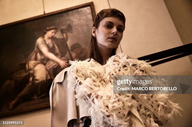 Model poses in the backstage prior to the Zambelli women's Fall/Winter 2019/2020 collection fashion show, on February 20, 2019 in Milan.