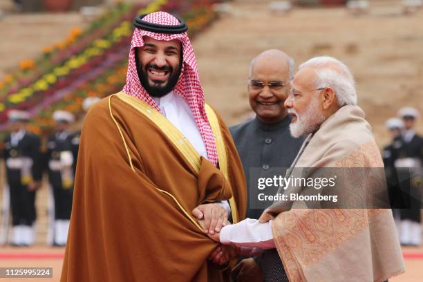 Mohammed Bin Salman, Saudi Arabia's crown prince, left, reacts as he is greeted by Ram Nath Kovind, India's president, center, and Narendra Modi,...