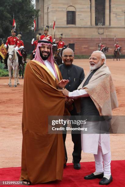 Mohammed Bin Salman, Saudi Arabia's crown prince, left, reacts as he is greeted by Ram Nath Kovind, India's president, center, and Narendra Modi,...