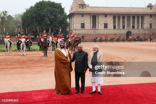 Mohammed Bin Salman, Saudi Arabia's crown prince, left, is greeted by Ram Nath Kovind, India's president, center, and Narendra Modi, India's prime...