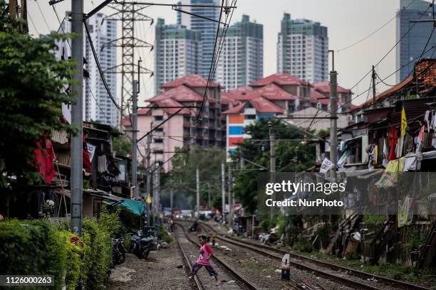 Girl play on a railway track in a slum area at Jakarta, Indonesia on February 20, 2019.