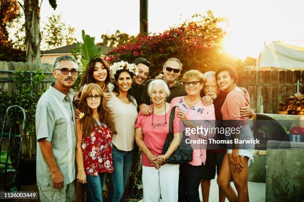 Portrait of multigenerational family in backyard during party on summer evening