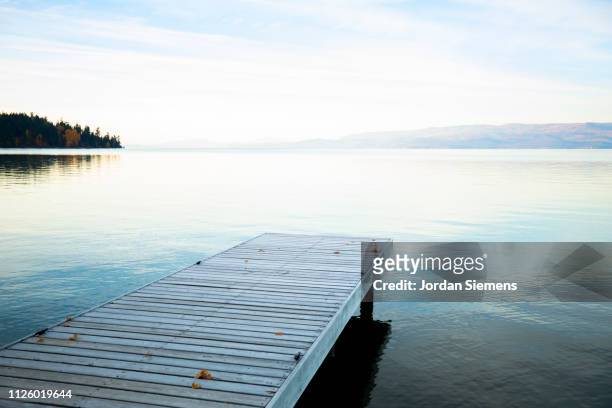 a beautiful dock on a lake at sunset - jetty ストックフォトと画像