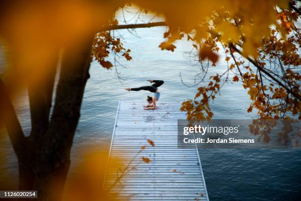 a woman doing yoga on a dock - lake whitefish stock-fotos und bilder