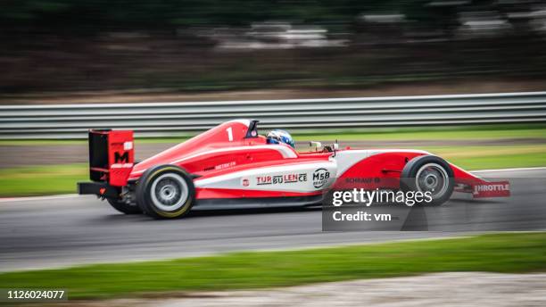 speeding red formula car - racing car driver stock pictures, royalty-free photos & images