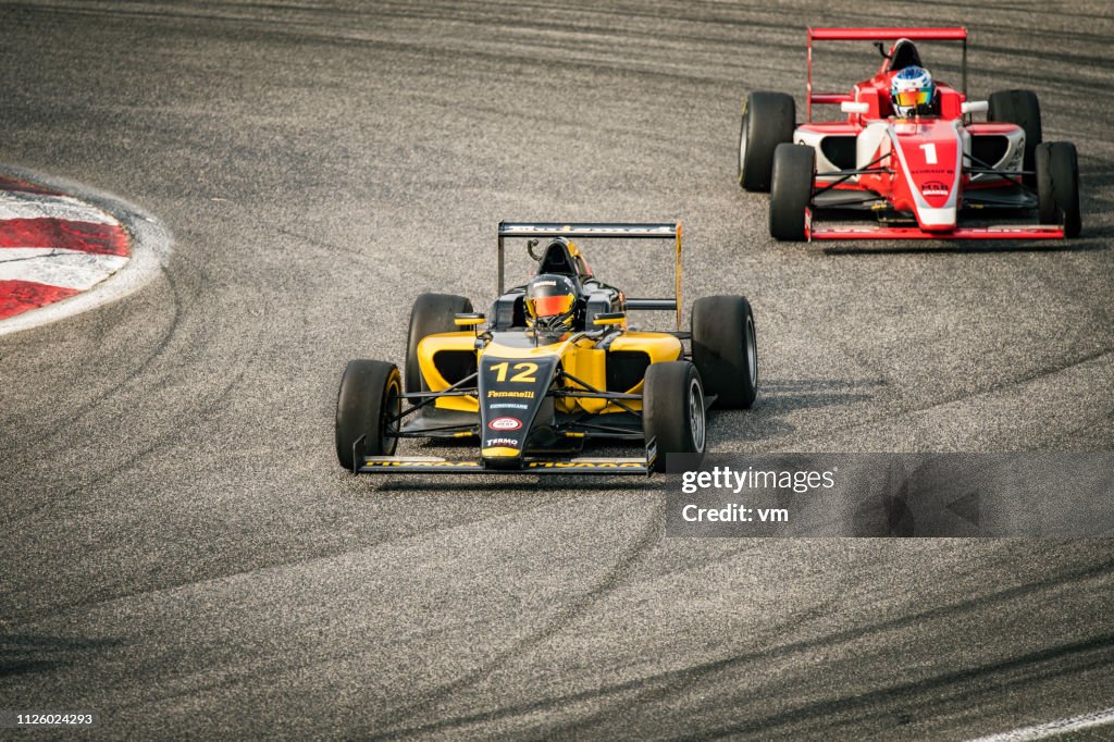 Open-wheel race cars on the track