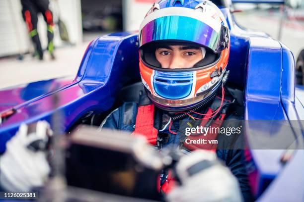 formula race car driver - car racing helmet stock pictures, royalty-free photos & images