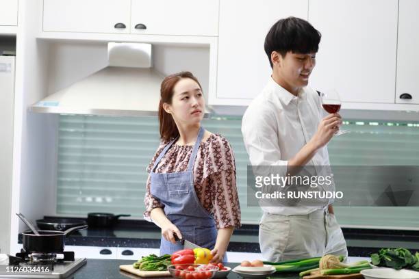 man drinking wine while woman looking displeased - the japanese wife foto e immagini stock