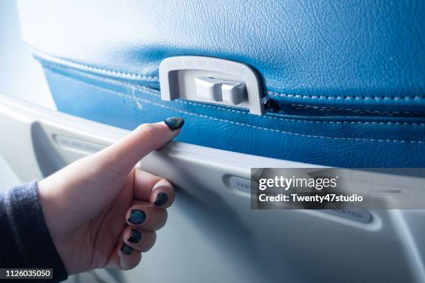 crop image of hand open passenger food tray in airplane - airplane tray stock-fotos und bilder