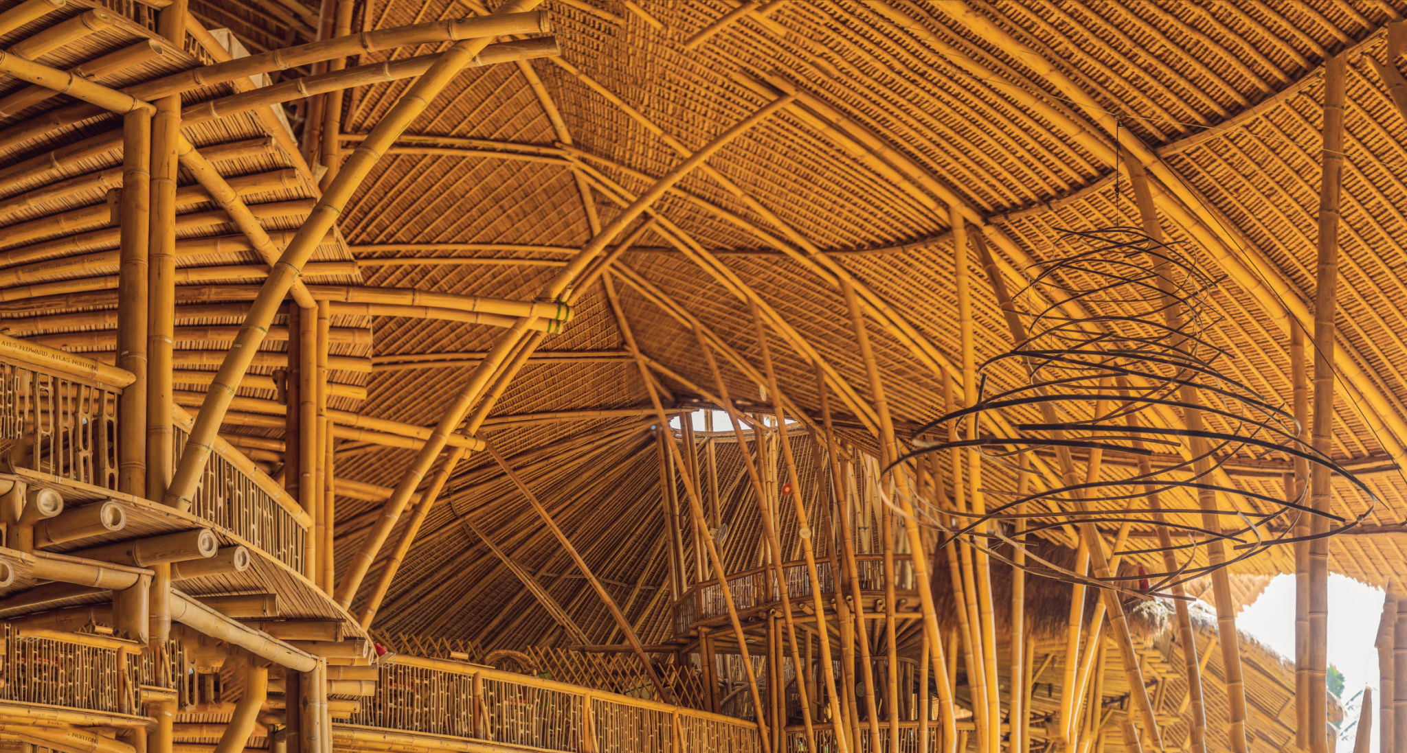 BALI, INDONESIA - MAY 2018: Green School Bamboo village, Traditional houses constructed by Bamboo with Thatch roof in the heart of Bukit Peninsula, Very unique and green concept BALI, INDONESIA - MAY 2018: Green School Bamboo village, Traditional houses constructed by Bamboo with Thatch roof in the heart of Bukit Peninsula, Very unique and green concept
