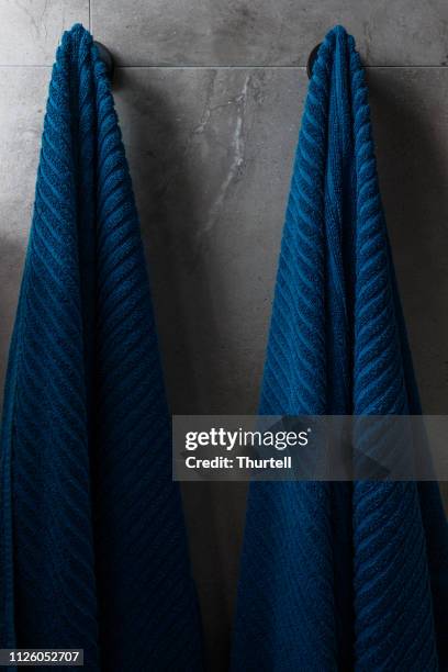 blue bath towels in modern apartment - home decor - en suite stock pictures, royalty-free photos & images