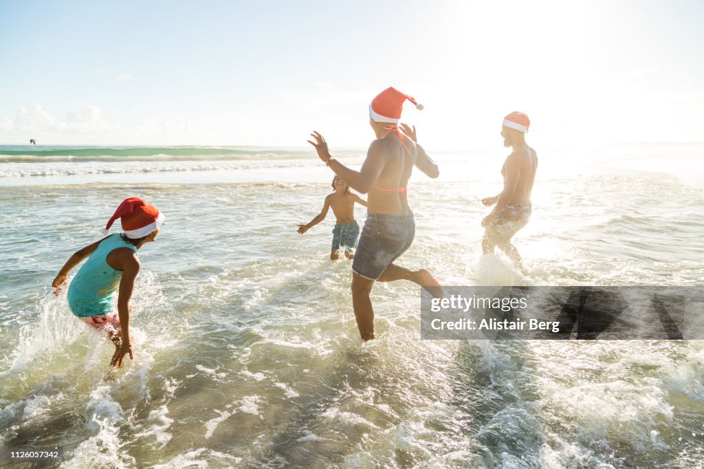 Family enjoying Christmas together on the beach