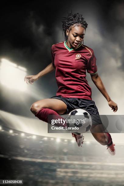 female football player in action in a stadium - soccer player stock pictures, royalty-free photos & images