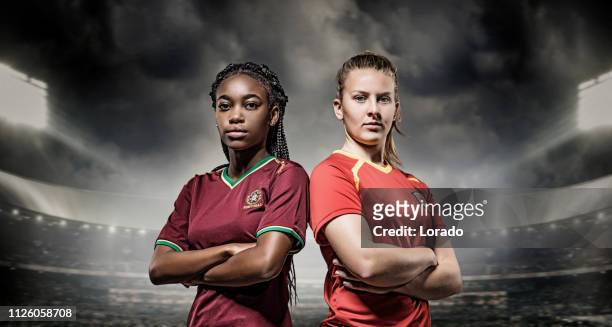 zwei weibliche fußball-spieler - woman football stock-fotos und bilder