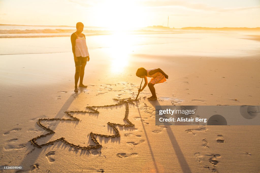 Mother and daughter playing together on the beach